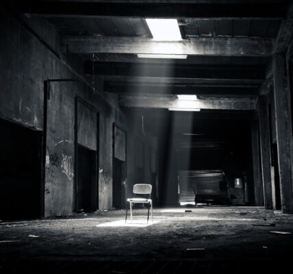 grayscale photo of chair inside the establishment