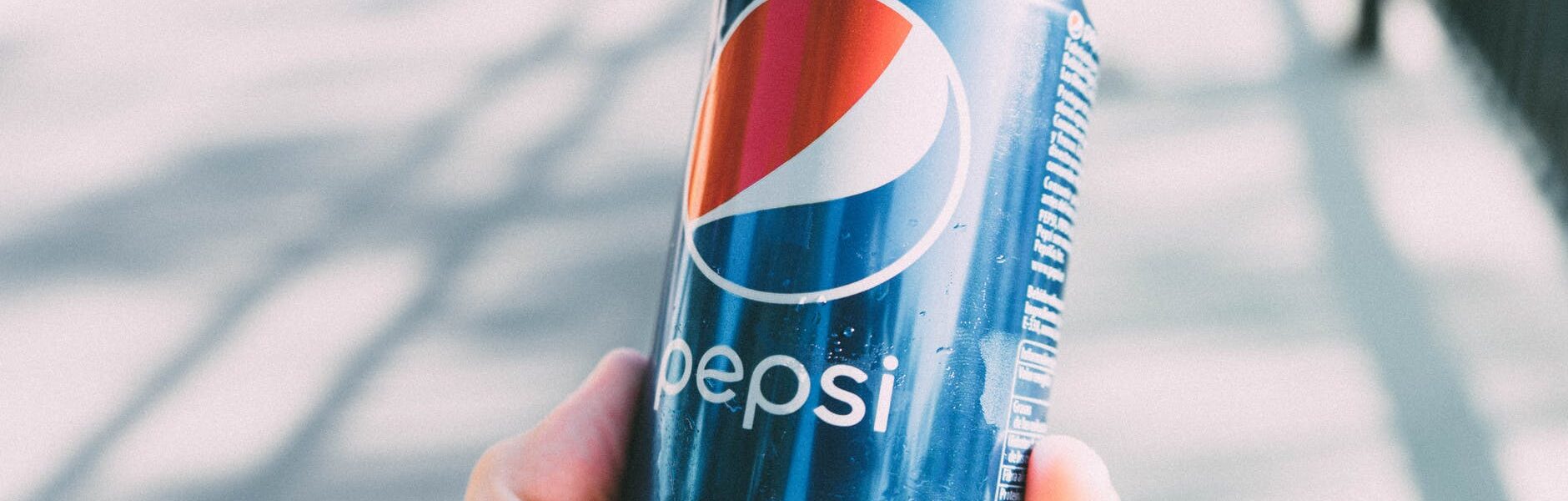 person holding pepsi can